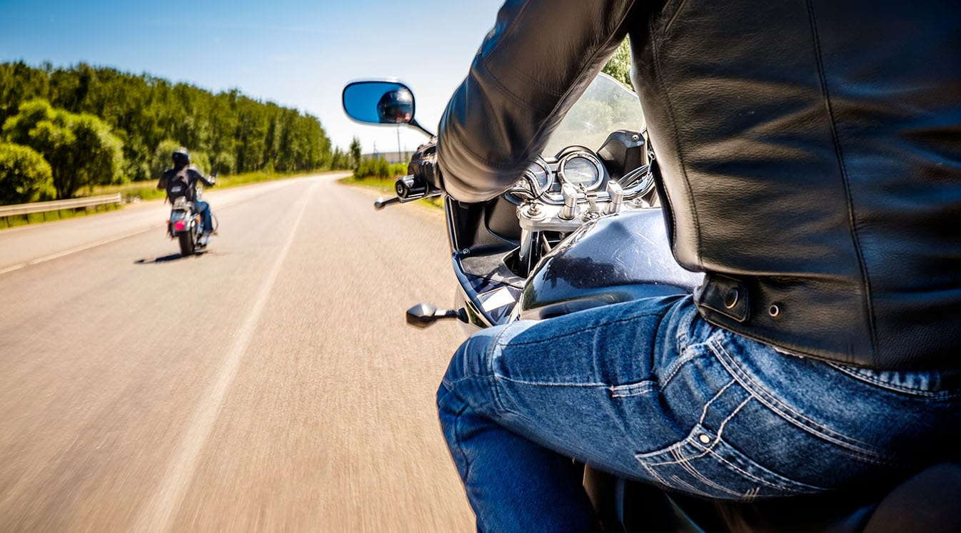 Bikers riding motorcycles on road