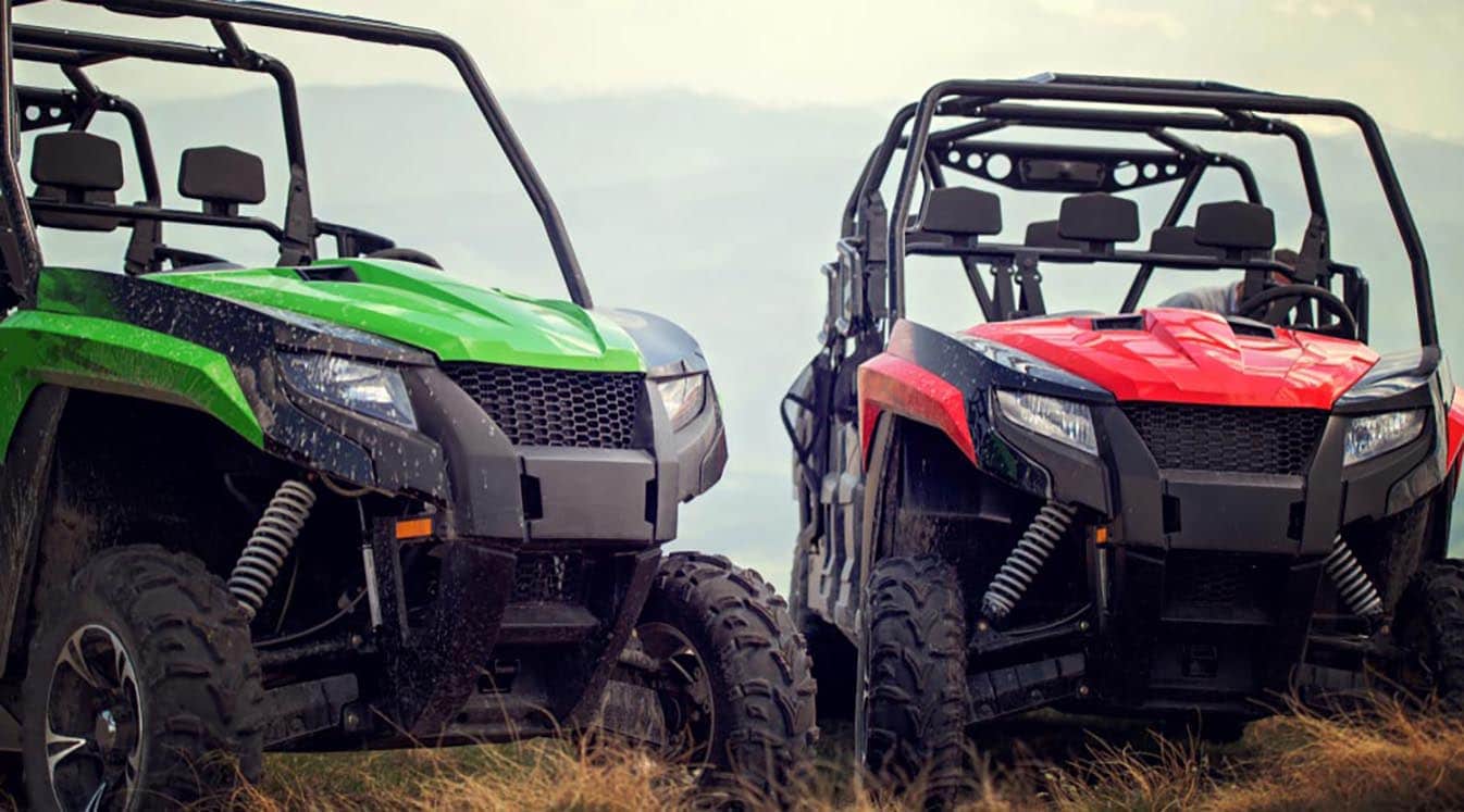 friends driving off road quad bikes