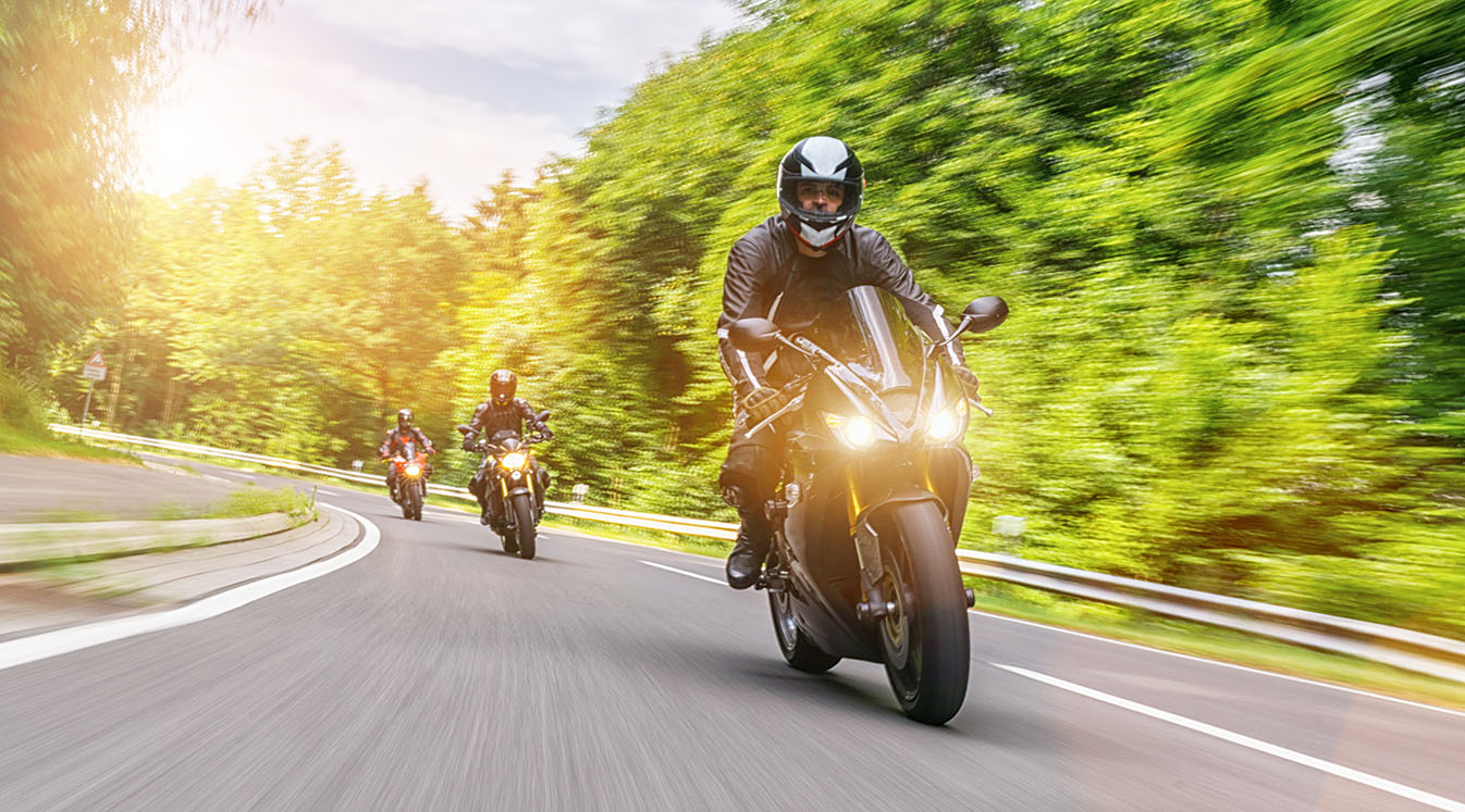 bikers riding on empty road