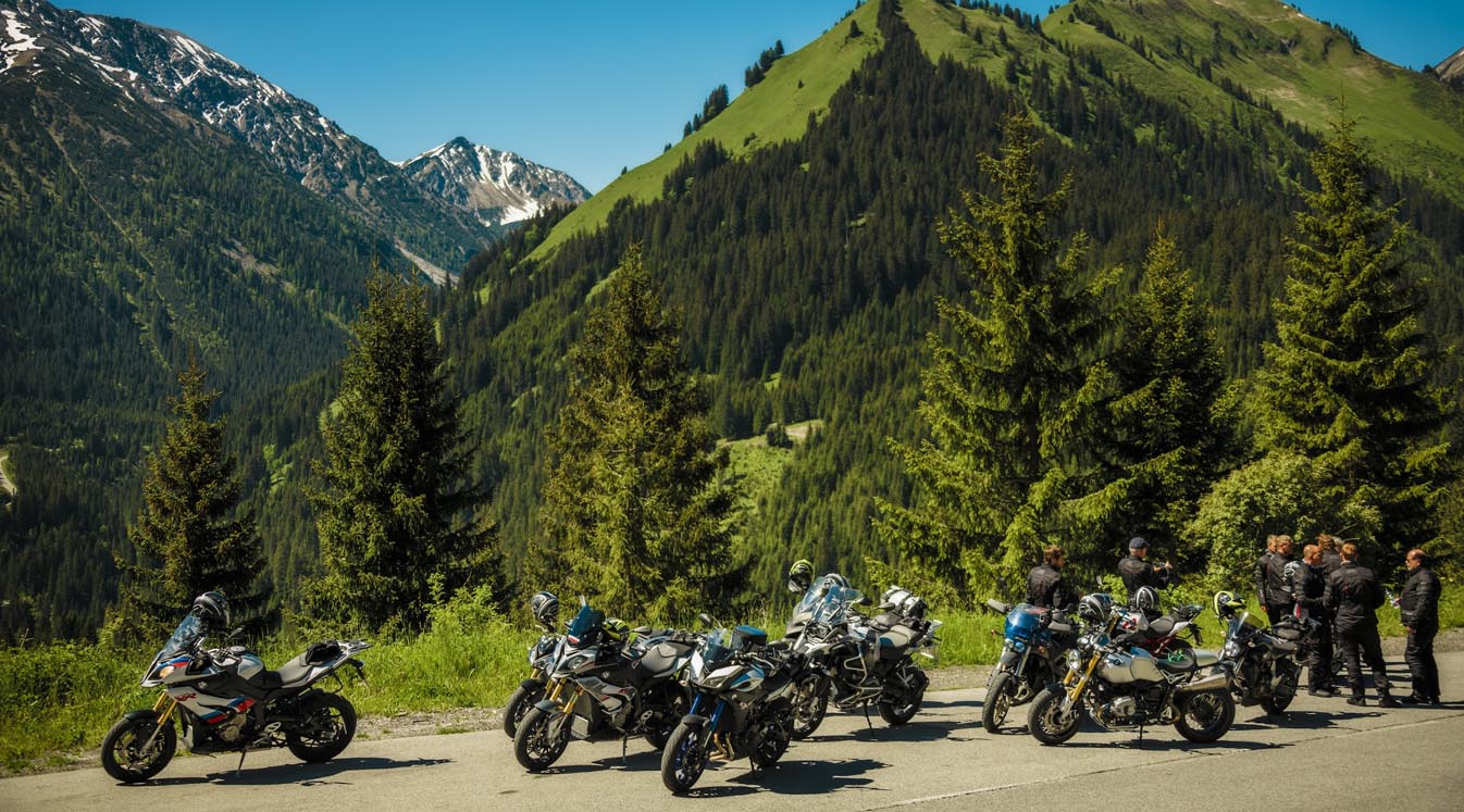 group of bikers parked on rugged roadside