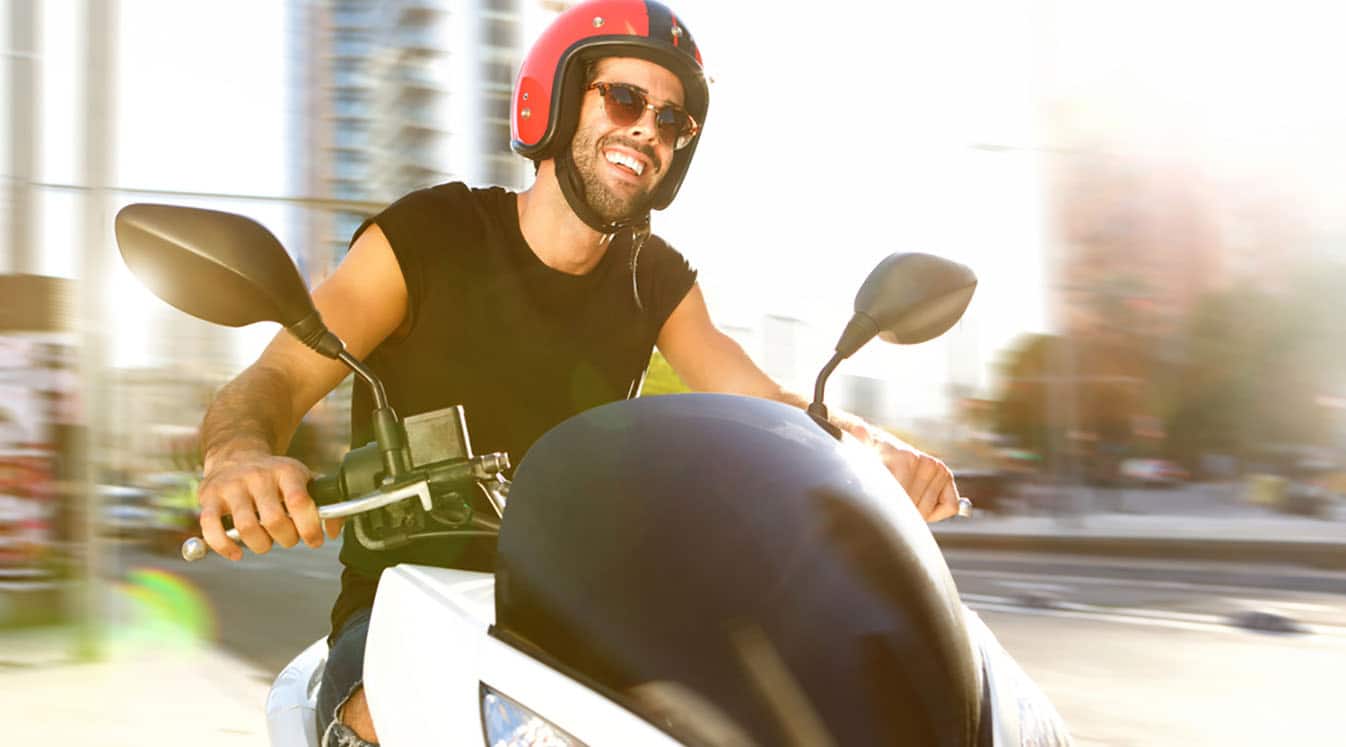 man smiling on motorcycle